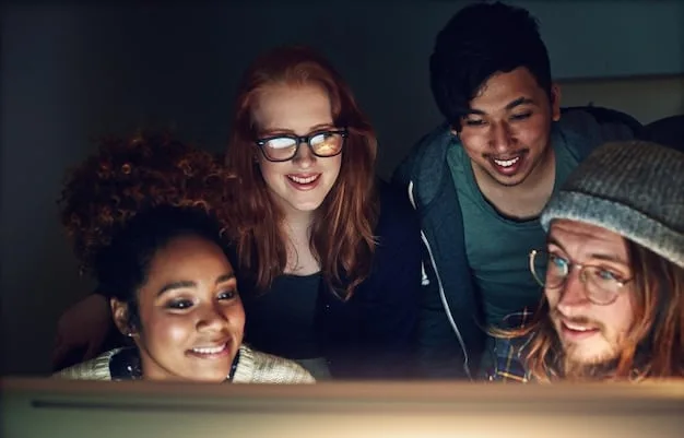 A diverse group of Gen Z students collaborating on a digital project in a modern classroom, with their faces illuminated by screens and engaged in active discussion.