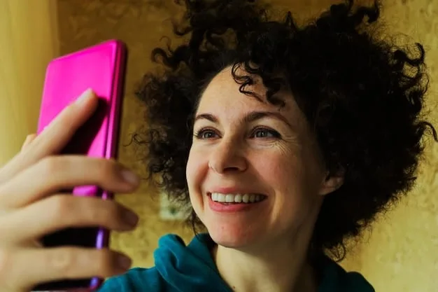 A young woman laughing while watching a short-form video on her smartphone, with colorful graphics and emojis subtly visible on the screen, indicating dynamic content. The background is softly blurred to keep focus on her and the phone.