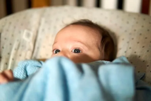 A calm, contented baby around 2 months old, lying on their back in a crib, gently sucking on their fist while looking towards the camera, indicating self-soothing or early hunger.
