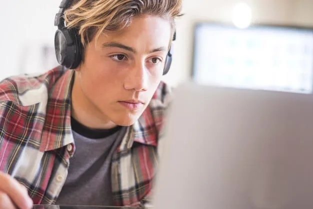 A Gen Z student attentively engaged in an online discussion forum on a laptop, with multiple chat bubbles and profile pictures visible, illustrating a high level of digital social interaction and collaborative learning.