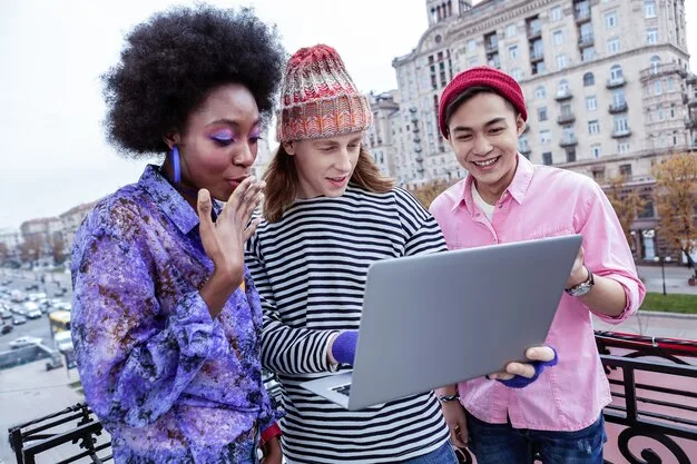 A digitally enhanced image of two diverse Gen Z individuals collaborating on a laptop, surrounded by floating social media icons and glowing chat bubbles, symbolizing collaborative digital communication.