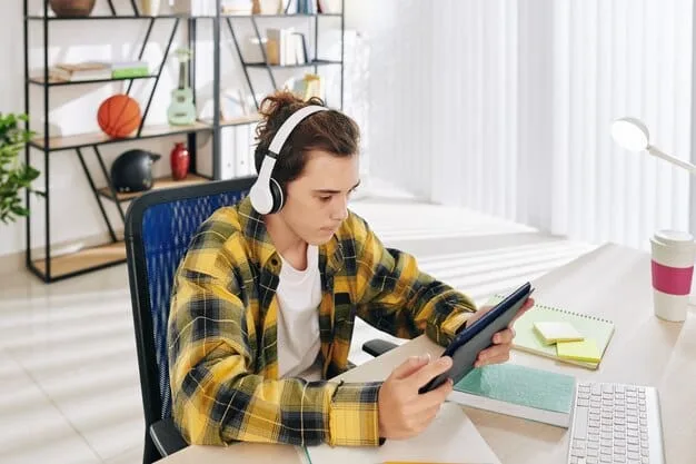 A Gen Z student wearing headphones, deeply engrossed in a lesson on a tablet, surrounded by other open tabs and digital devices, showcasing multi-screen learning and digital immersion.