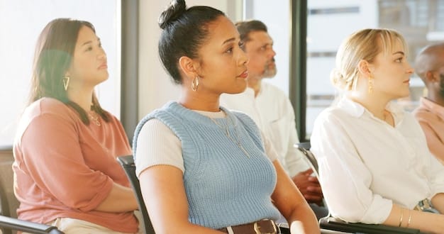 A group of diverse community members participating in a job training workshop, with instructors providing hands-on guidance. The image should convey collaboration, empowerment, and the potential for economic advancement.