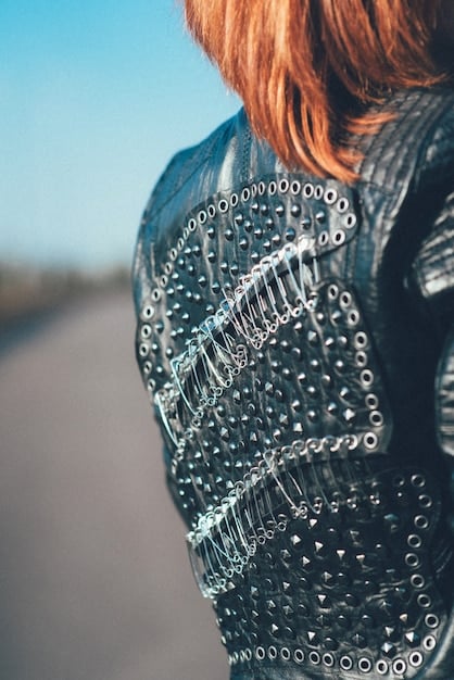 A close-up of a jacket made from recycled plastic bottles, showcasing the texture and innovative design. The background features a blurred cityscape, emphasizing the urban context of the garment.