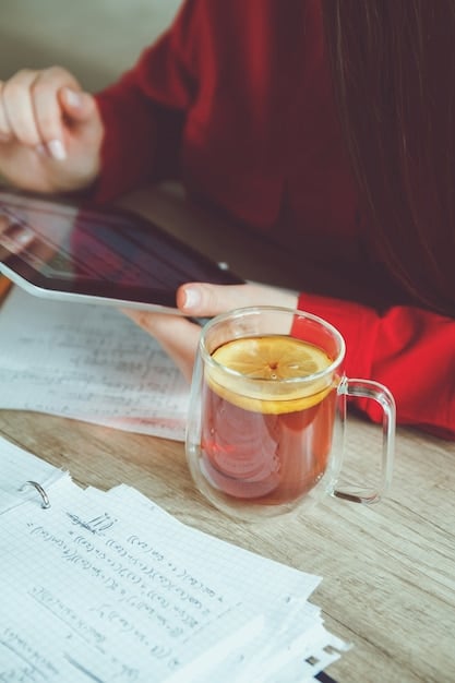 A person writing in a journal, visibly relaxed and focused, with a cup of tea nearby.