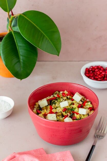 A close-up shot of a vibrant, colorful flexitarian bowl filled with roasted vegetables, quinoa, chickpeas, avocado, and a plant-based dressing, emphasizing healthy and appealing plant-forward eating.