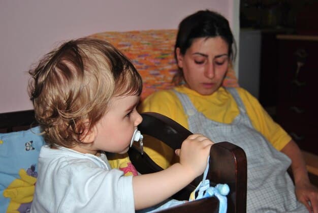 A caregiver gently consoling a crying toddler, demonstrating responsive parenting and the establishment of trust and comfort.