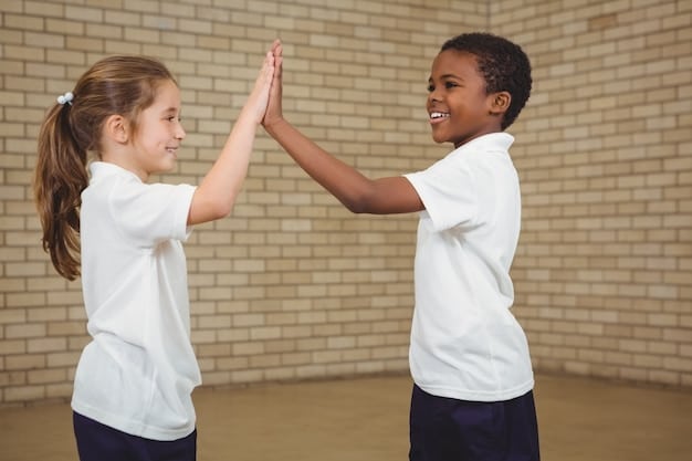 Two preschoolers enthusiastically holding hands and jumping together in a school playground, demonstrating joyful cooperation and strong peer bonds.