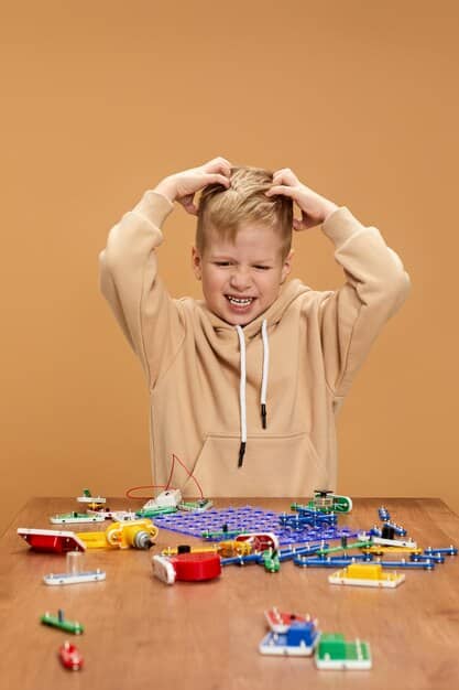 A determined preschooler concentrating intently on fitting together complex interlocking building toys, surrounded by partially constructed creations, illustrating focused problem-solving and perseverance.