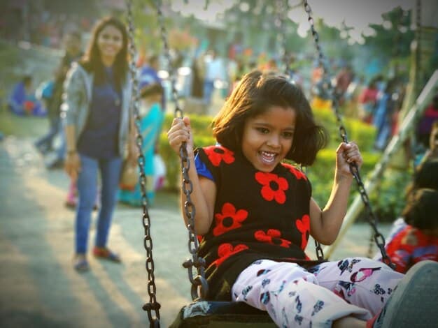 A diverse group of children with varying abilities playing together in an inclusive playground, symbolizing community and acceptance.