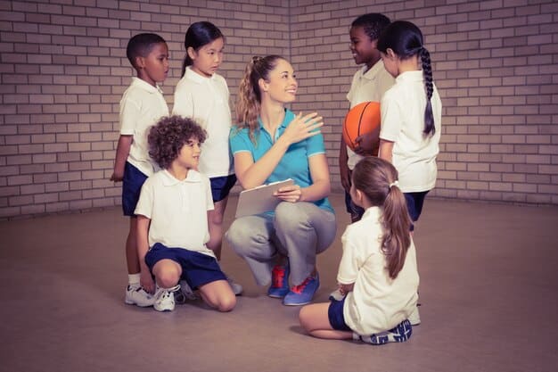 A group of diverse young children, around 3-6 years old, sitting in a circle during a music class. One child is shaking a maraca, another is tapping a drum, and a teacher or adult is guiding them with a gentle smile.