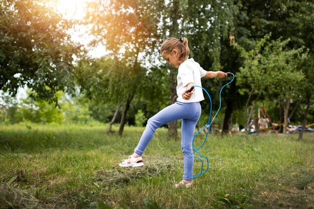 A child engaged in outdoor play, running and jumping, demonstrating healthy physical activity for energy regulation.