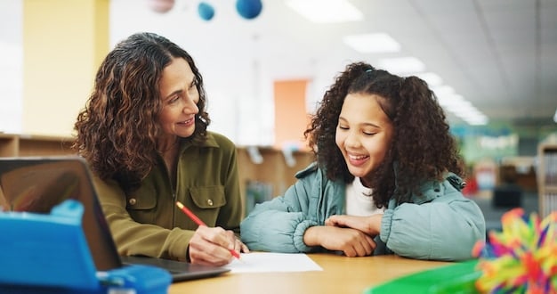 A teacher smiling and interacting individually with a student at a desk, while other students in the background are engaged in different self-directed learning activities, showcasing a personalized classroom environment.