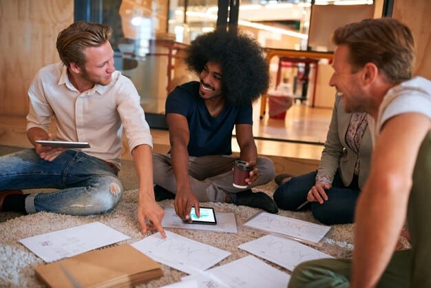 A group of diverse Gen Z young adults are seen collaborating on a project in a modern, open office or co-working space, demonstrating teamwork and positive communication, reflecting future career readiness.