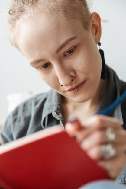 A close-up of a Gen Z student engaged in focused note-taking and active reviewing of flashcards, demonstrating personalized study techniques.