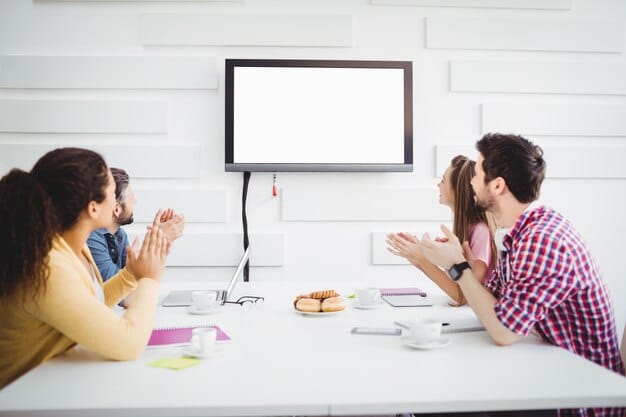 A teacher facilitating a study group of Gen Z students using a blend of traditional whiteboards and digital screens, promoting interactive learning and discussion.