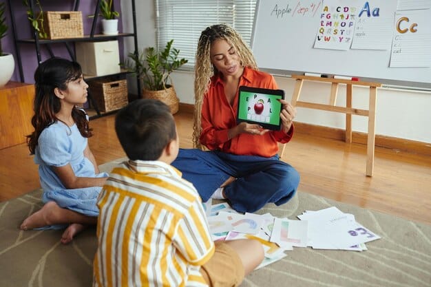 A Gen Z child excitedly pointing at a colorful alphabet chart, with a teacher smiling encouragingly in the background, illustrating early literacy development.