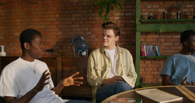 An educator making eye contact and having a calm, reassuring conversation with a Gen Z student in a classroom setting, conveying empathy and connection.