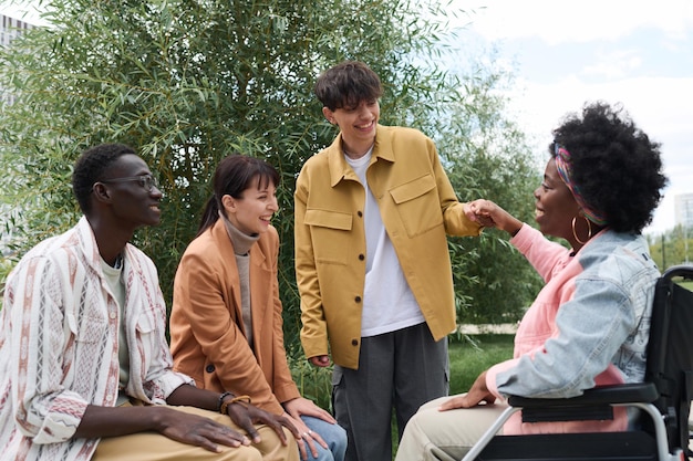 A group of young people participating in a community-based rehabilitation program, showing positive social interaction and mentorship.