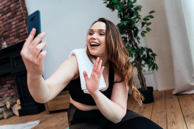 A young woman laughing while scrolling through her TikTok feed on a smartphone, with dynamic, colorful short-form videos playing on the screen. The background is a bright, modern cafe, suggesting casual, everyday use.