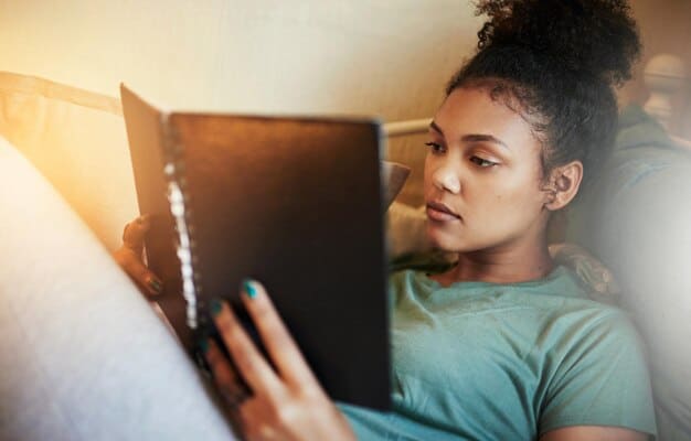 A young American Gen Z person looking contemplatively at a digital news feed displaying headlines about global crises, reflecting feelings of overwhelmed anxiety. Darker, more somber tones.