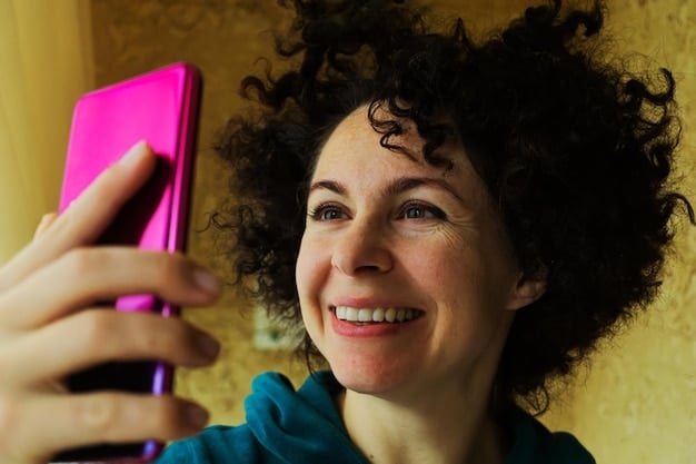 A young woman laughing while watching a short-form video on her smartphone, with colorful graphics and emojis subtly visible on the screen, indicating dynamic content. The background is softly blurred to keep focus on her and the phone.