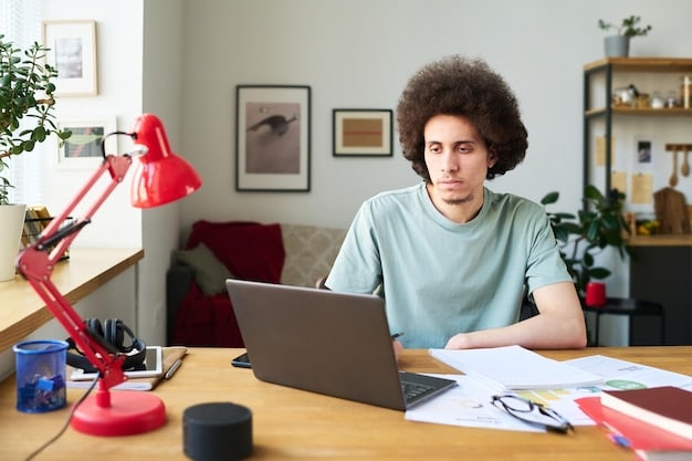 A young person, possibly a student, sitting at a desk with a laptop open, but focused on a budgeting or productivity app open on their smartphone, illustrating thoughtful digital use. Soft, warm lighting suggests a focused environment.