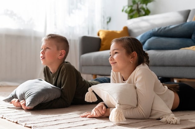 Two children, about 8-9 years old, are sitting facing each other on a carpet, thoughtfully discussing something. They are gesturing with their hands, and one child is holding a shared toy, suggesting a collaborative problem-solving scenario. The expressions are serious but engaged.