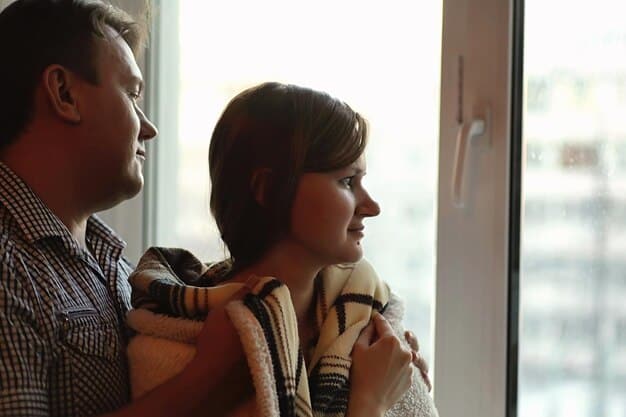 A parent patiently comforting a child who is looking away. The scene suggests gentle understanding and support, with soft lighting and a warm atmosphere. The child's posture indicates a slow-to-warm-up or hesitant temperament.
