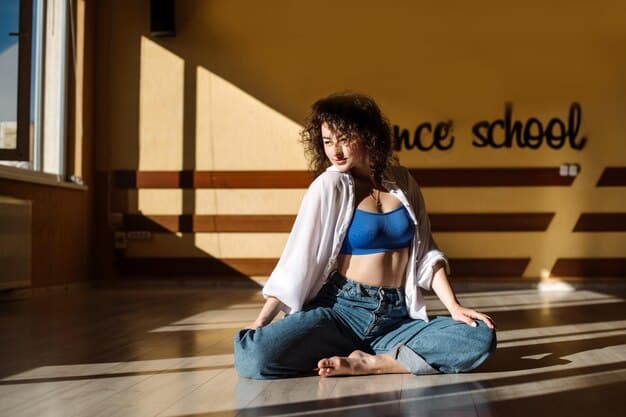 A young Gen Z student, perhaps female, sitting quietly with eyes closed, performing a mindful breathing exercise in a busy college library, symbolizing focus amidst distraction.